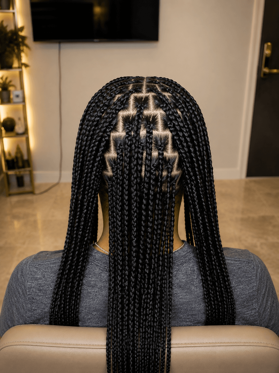Long black box braids with clean geometric parting — back view