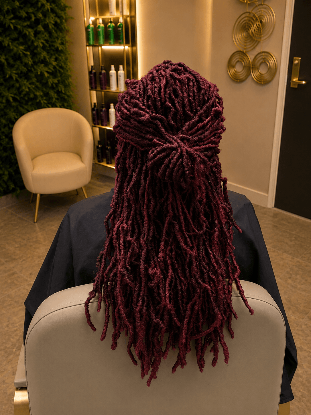 Burgundy distressed faux locs in half-up style — back view