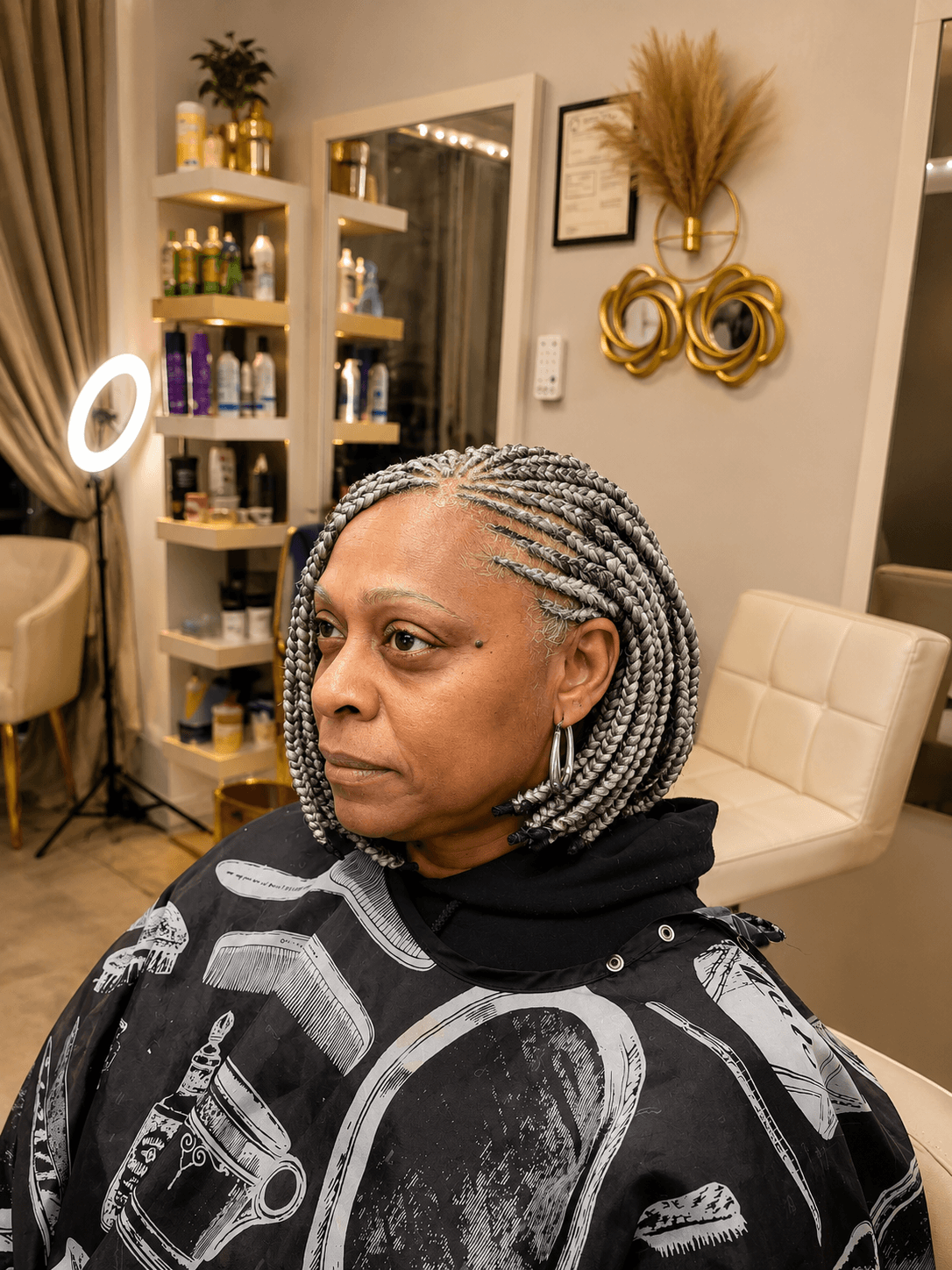 Gray silver knotless bob braids — front three-quarter view in salon