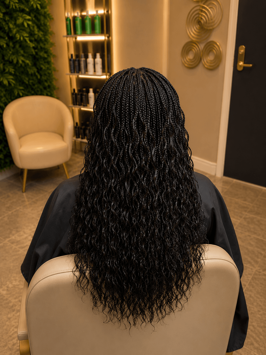Long black knotless braids with wavy curly ends — mid-back length