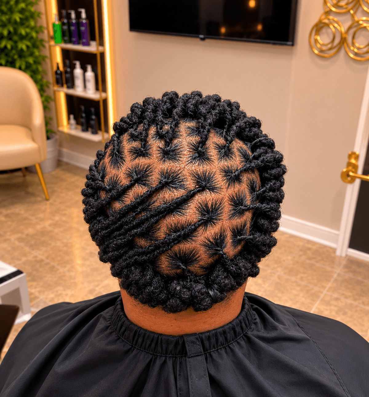Short black kinky coil twists with diagonal design pattern — top view