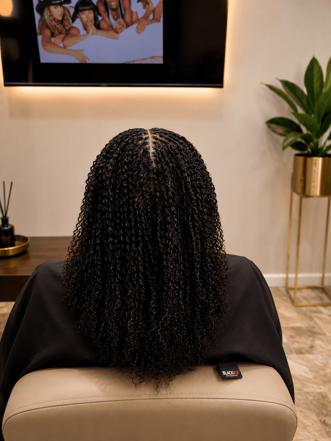 Short black passion twists with curly ends — back view