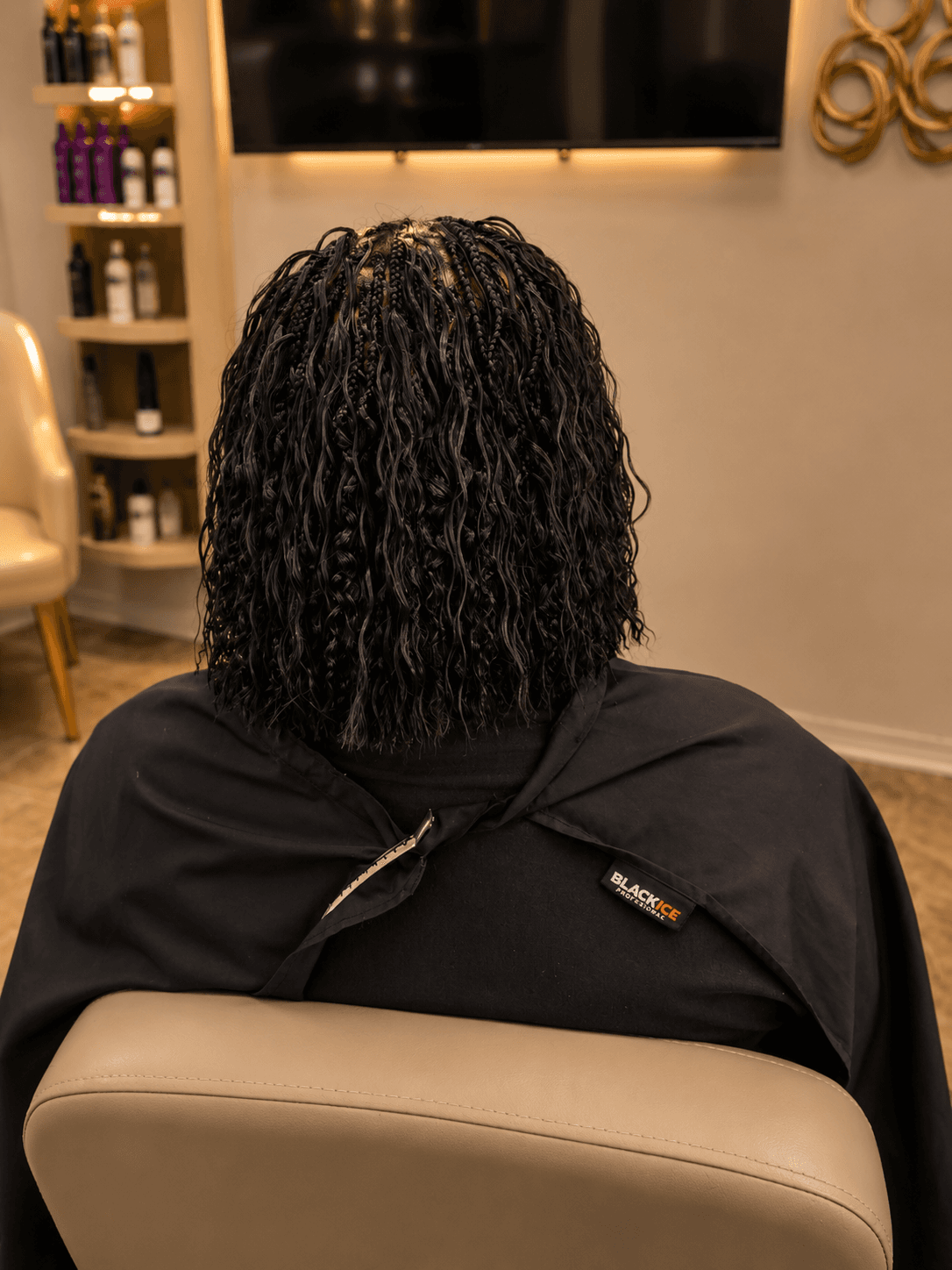 Short black spring twists bob — back view in salon